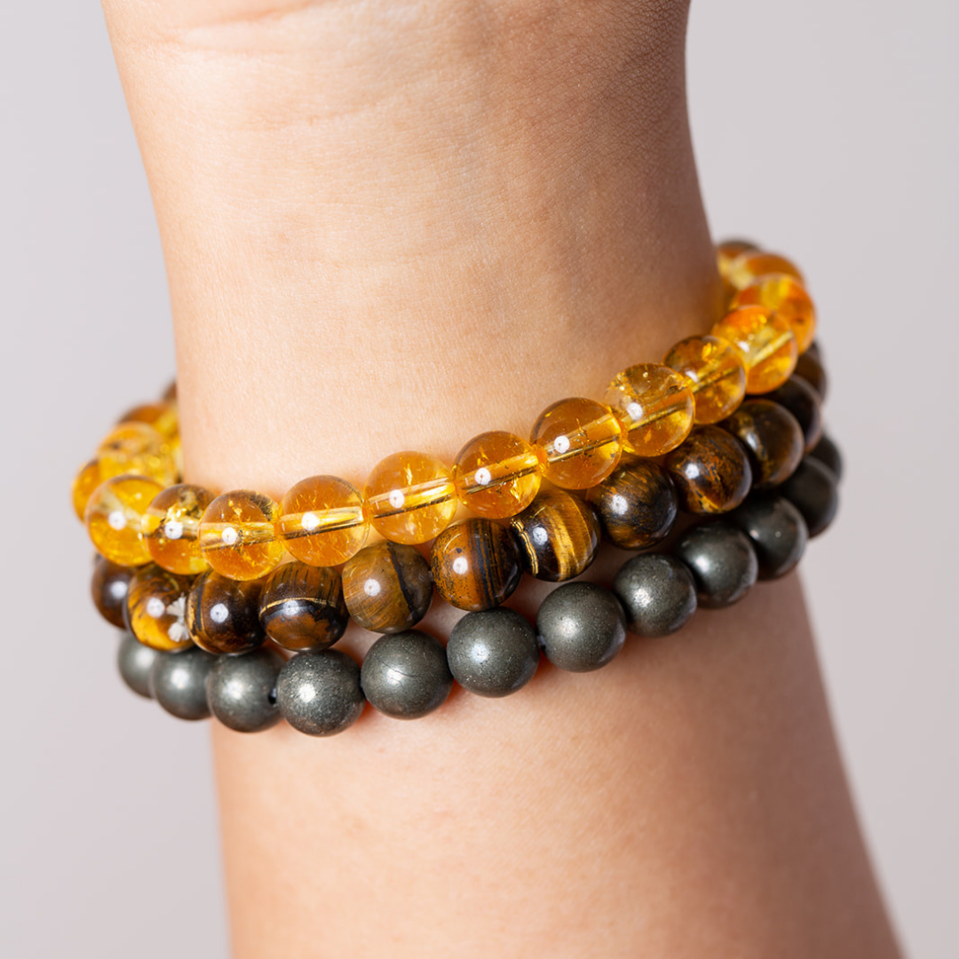 Women's wrist with Ambarya citrine, tiger's eye and pyrite mala beads