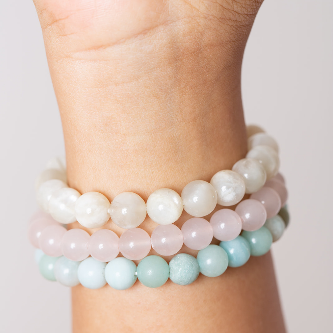 women's wrist with Ambarya moonstone, rose quartz, amazonite mala beads