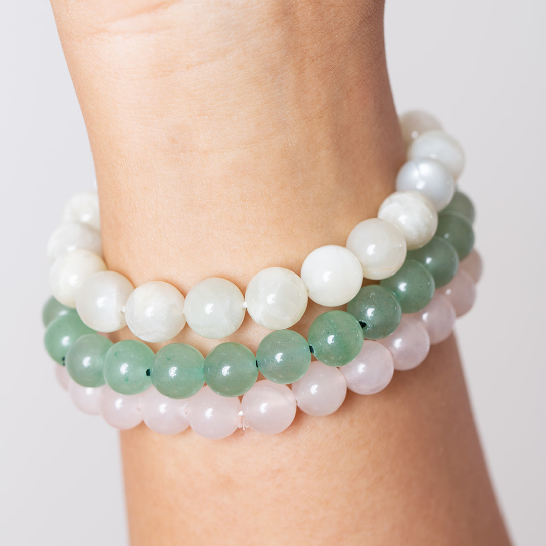 womens wrist with Ambarya moonstone, green aventurine and rose quartz mala beads