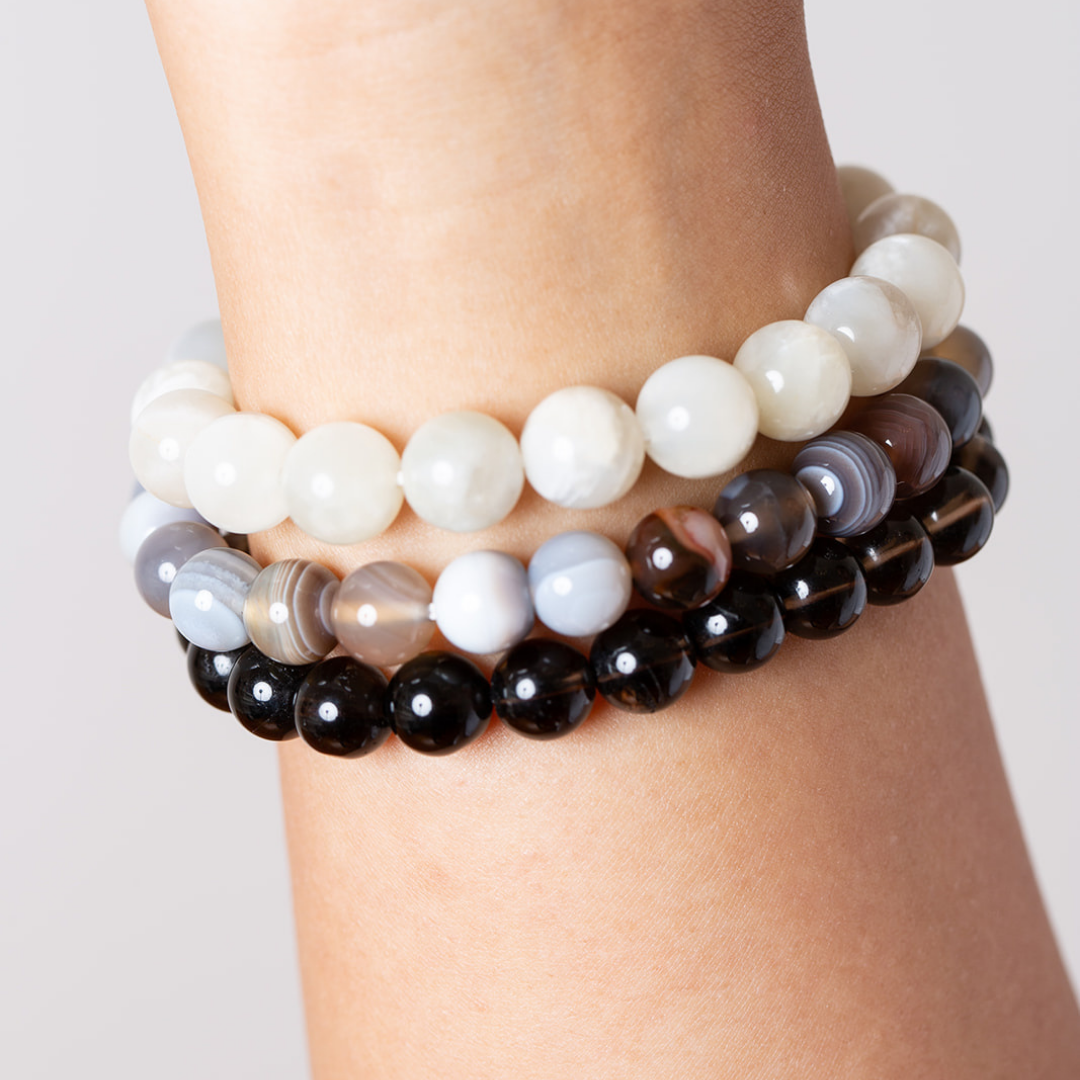women's wrist with Ambarya moonstone. botswana agate and smoky quartz mala beads