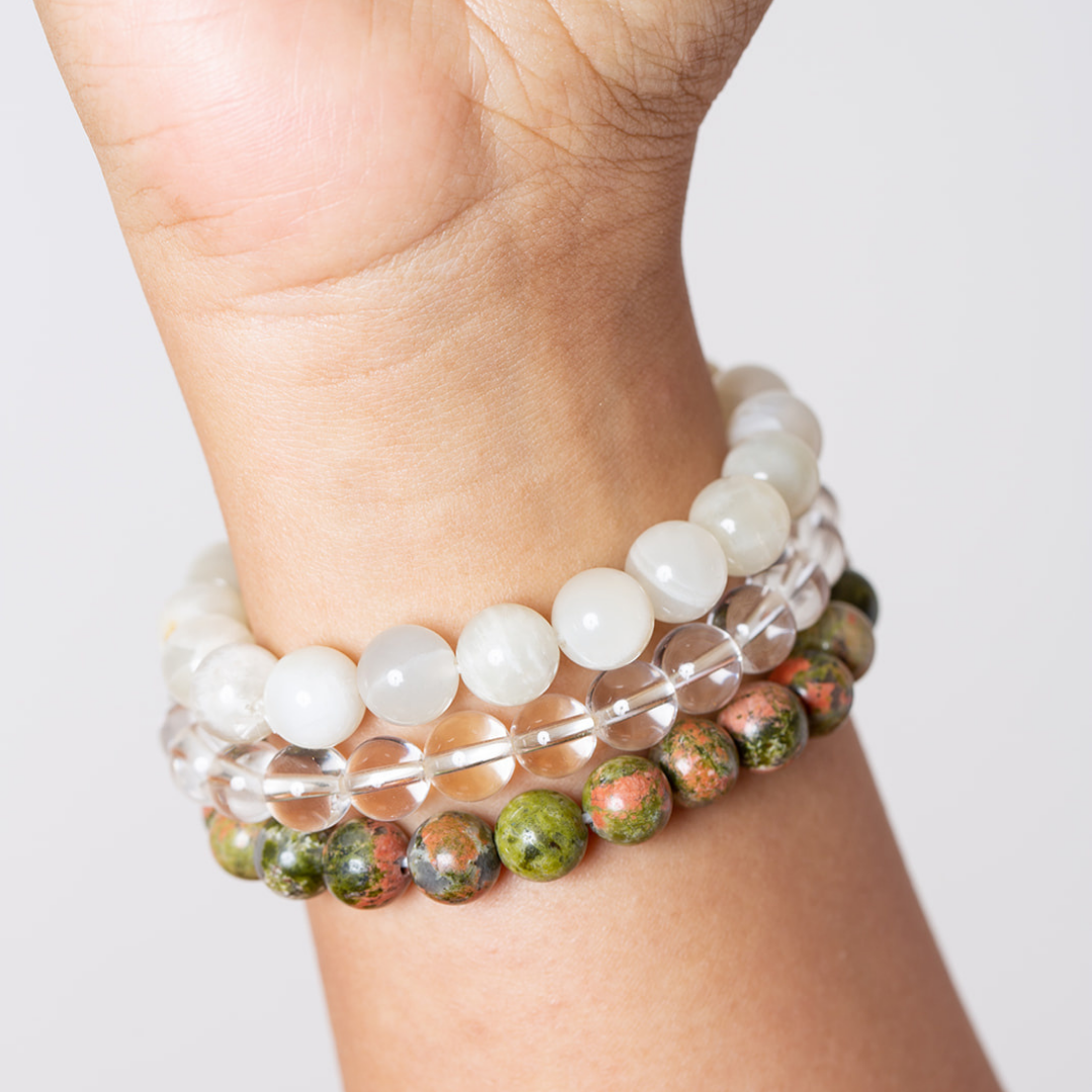 women's wrist with Ambarya moonstone, clear quartz, unakaite mala beads