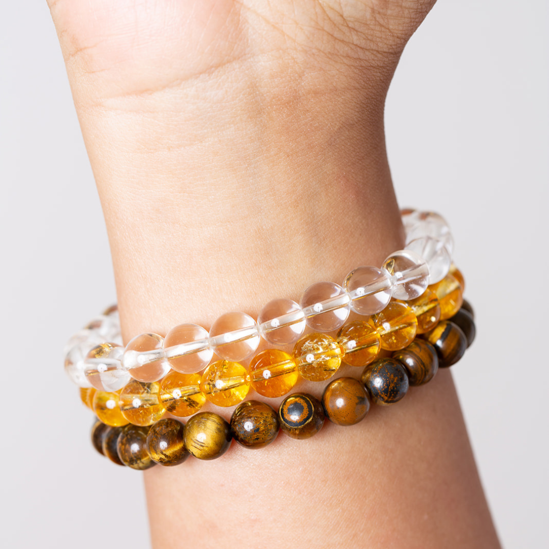 women's wrist with Ambarya clear quartz, citrine and tiger's eye mala beads