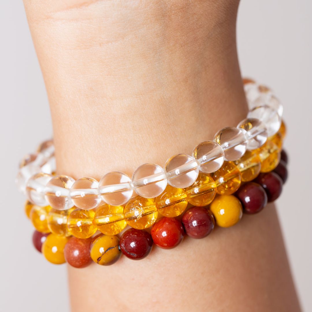 women's wrist with Ambarya clear quartz, citrine and mookaite mala beads