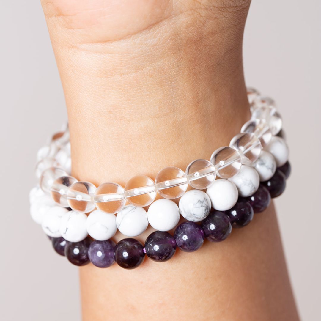 womens wrist with clear quartz, howlite and amethyst mala beads