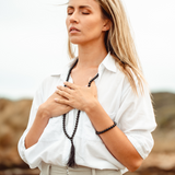 Woman with eyes closed hands on heart wearing Black Tourmaline crystal Mala Bead Set