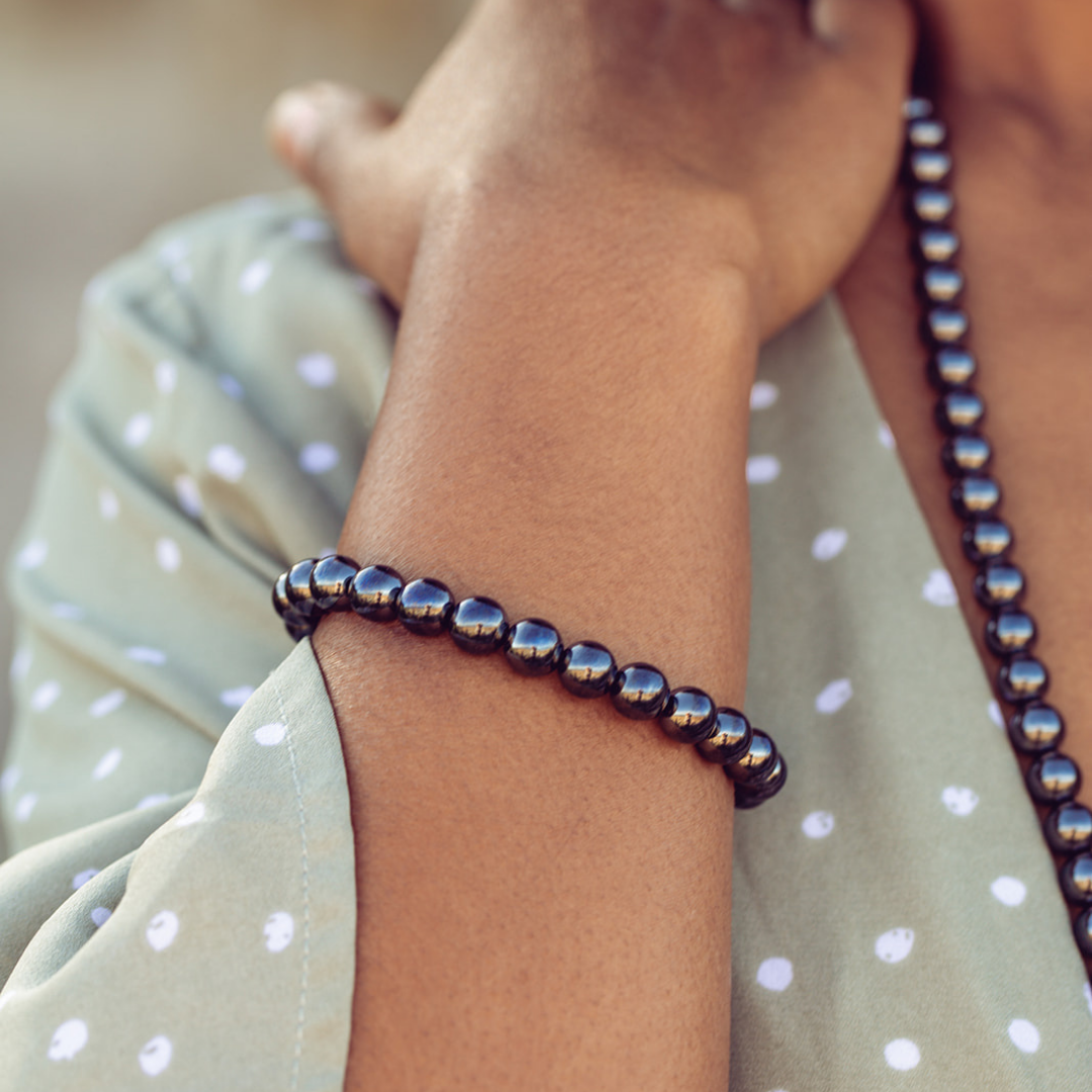 Close up of woman's wrist wearing Ambarya Strength - Hematite Mala Bead bracelet