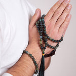 Man with Ambarya Support - Moss Agate Mala Bead Necklace wrapped around his hands