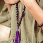 Close up of Amethyst Crystal Mala Bead necklace on woman