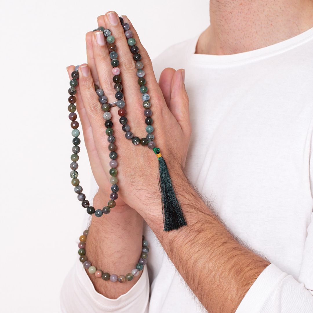 Man with Ambarya Good health - Bloodstone crystal Mala Bead Necklace draped over his fingers and wearing bloodstone mala bead bracelet