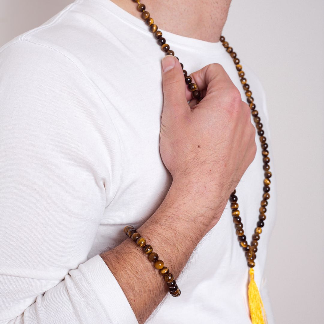 Man wearing Ambarya Courage - Tiger’s Eye crystal Mala Bead Necklace and Bracelet Set. He is