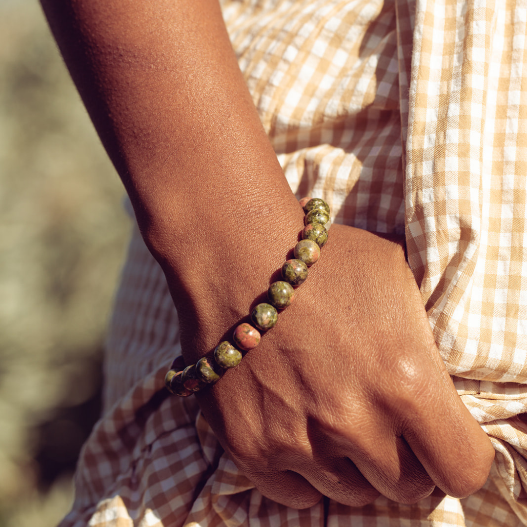 Close up of woman's wrist wearing Ambarya Harmony - Unakite mala bead bracelet