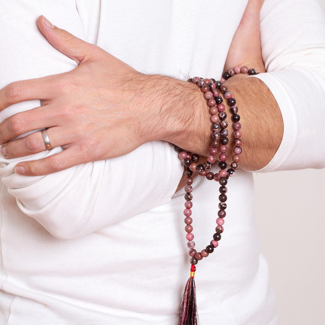 Man with Ambarya Emotional Balance - Rhodonite crystal Mala Bead Necklace wrapped around his wrist