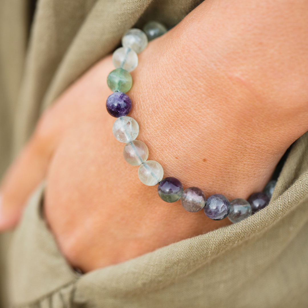 Close up of Woman wearing Rainbow Fluorite crystal Mala Bead bracelet