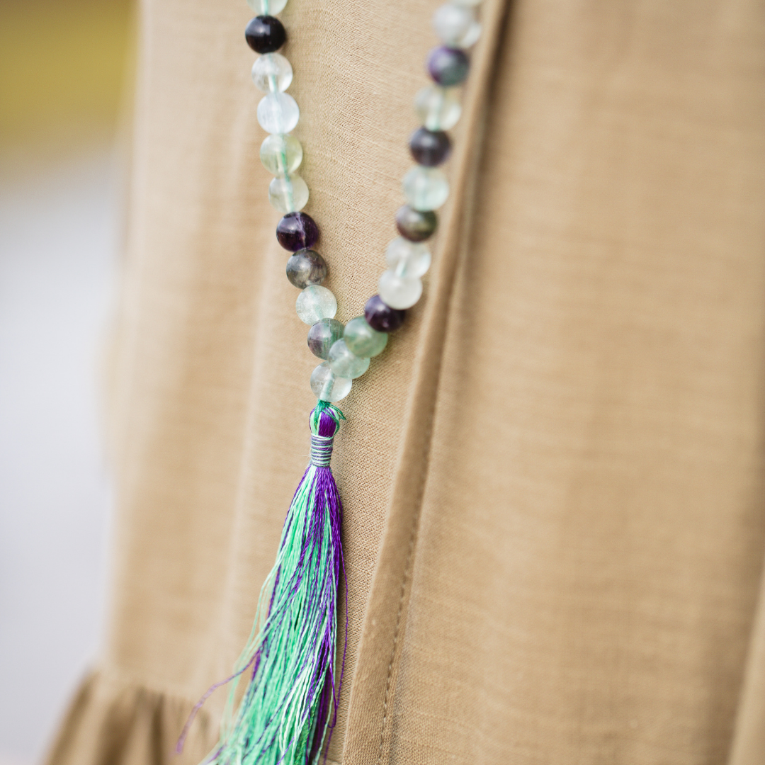Close up of Woman wearing Rainbow Fluorite crystal Mala Bead necklace