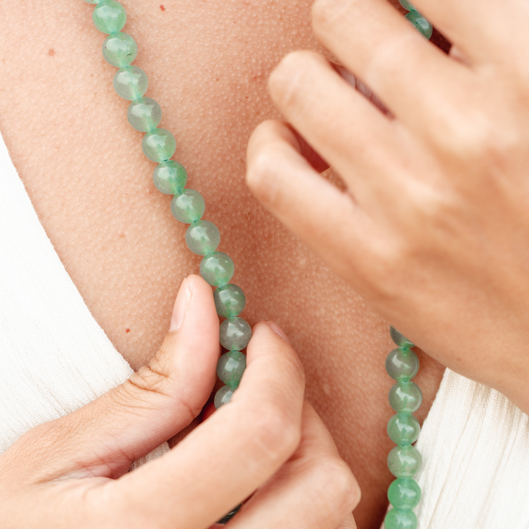 Up close shot of Green Aventurine Mala Bead Necklace on woman's chest