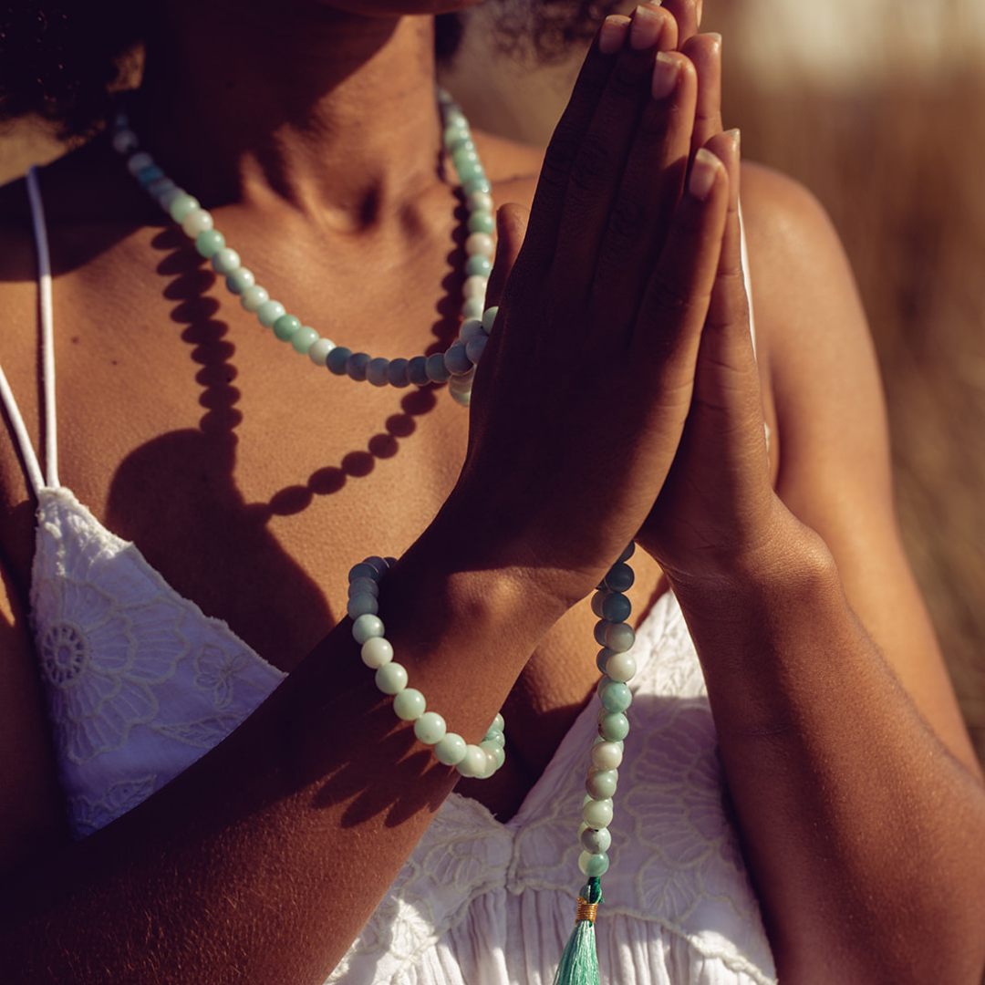 Close up of woman hands in prayer position wearing Ambarya Hope - Amazonite Mala Bead Set