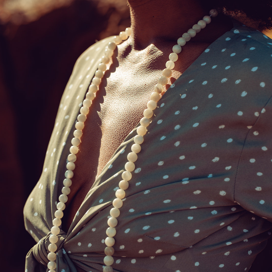 Close up of Ambarya New Beginnings - Moonstone Mala Bead Necklace around woman's neck