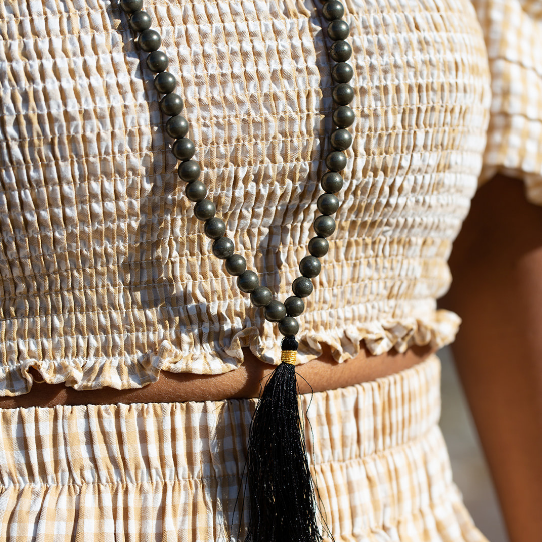 Close up on woman wearing Ambarya Willpower - Pyrite Mala Bead Necklace